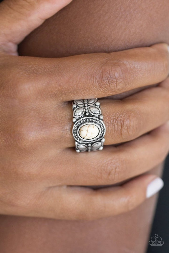 A refreshing white stone is pressed into a shimmery silver band radiating with butterfly details for a whimsical look. Features a stretchy band for a flexible fit.  Sold as one individual ring.