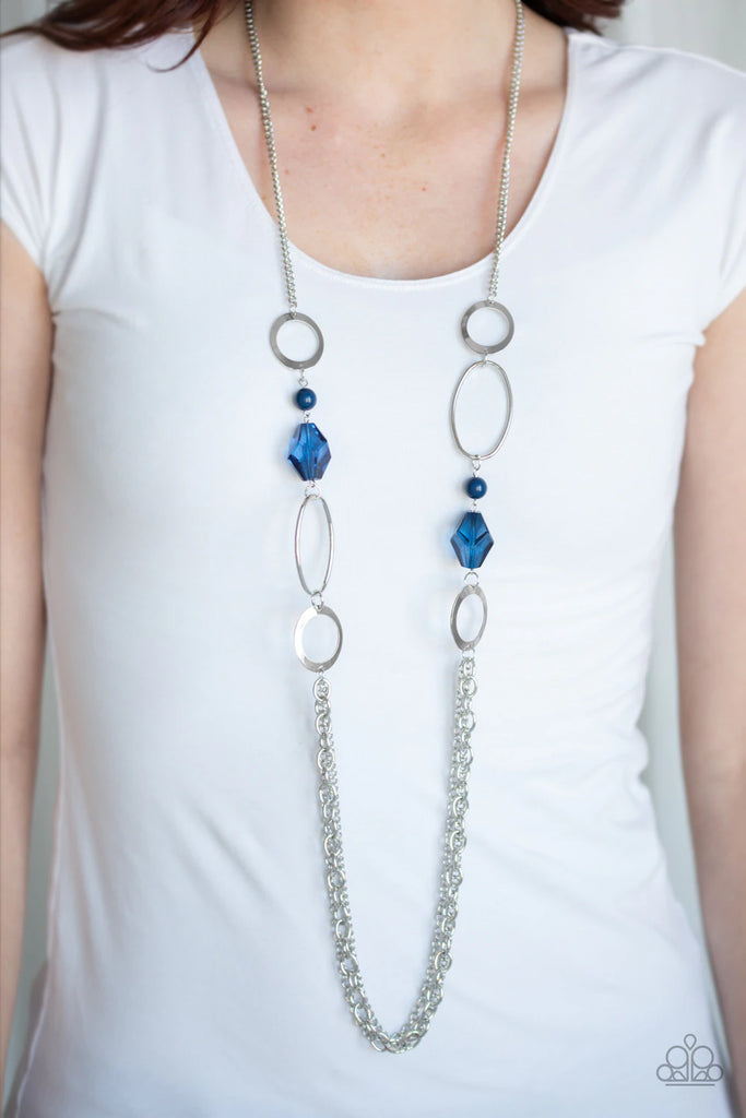 Featuring Evening Blue crystal-like and dainty Evening Blue beads, an array of shimmery silver hoops give way to layers of glistening silver chains across the chest for a classic look. Features an adjustable clasp closure.  Sold as one individual necklace. Includes one pair of matching earrings.