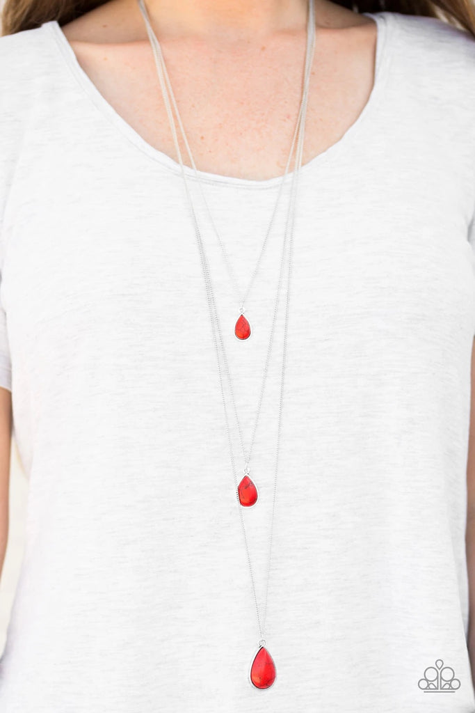 Featuring a true red palette, fiery teardrops trickle down the chest in shimmery layers. Featuring a polished finish, the stone pendants gradually increase in size for a tranquil finish. Features an adjustable clasp closure.  Sold as one individual necklace. Includes one pair of matching earrings.