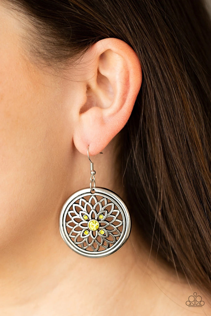 Dotted with a glittery yellow rhinestone center, airy silver petals bloom across the front of a rustic silver hoop, creating a sparkly medallion-like frame. Earring attaches to a standard fishhook fitting.  Sold as one pair of earrings.