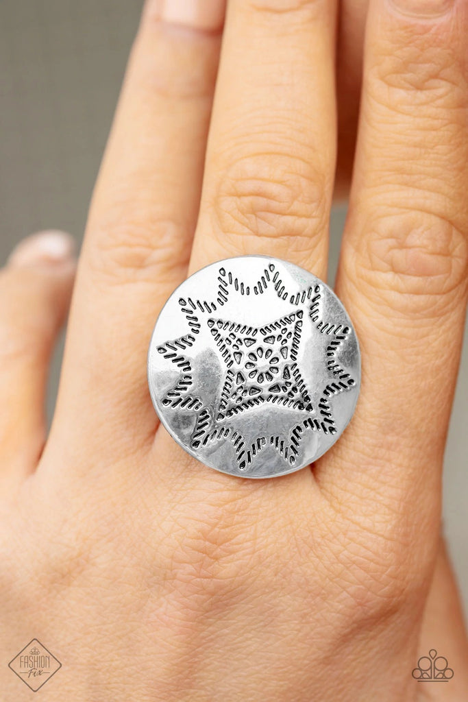 A shiny silver disc dotted in a radiant sunburst pattern fans out atop the finger for a seasonal look. Features a stretchy band for a flexible fit.  Sold as one individual ring.