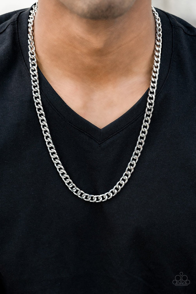 Featuring classic curb link chain, a thick silver chain drapes across the chest for a game changing look. Features an adjustable clasp closure.  Sold as one individual necklace.