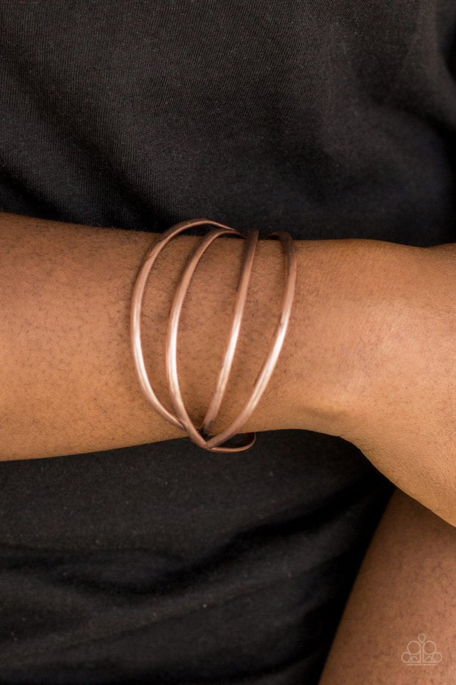 Glistening copper bars arc across the wrist, coalescing into an airy cuff.  Sold as one individual bracelet.