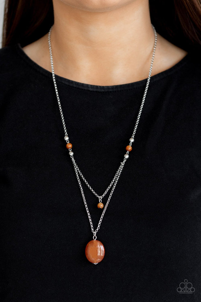 Rows of dainty silver and glassy orange beads give way to two shimmery silver chain layers. A dainty orange bead swings from the uppermost strand, while a glassy orange stone pendant swings from the lowermost chain for a stacked look. Features an adjustable clasp closure.  Sold as one individual necklace. Includes one pair of matching earrings.