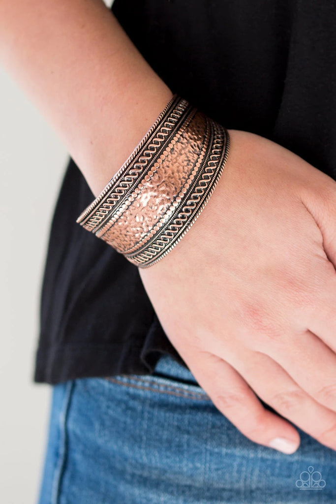 Hammered, studded, and embossed in tribal inspired textures, a thick copper cuff curls around the wrist for a artisan inspired look.  Sold as one individual bracelet.