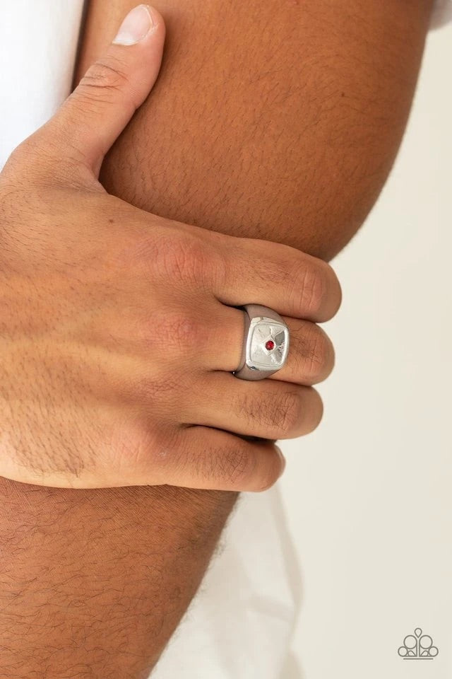 A solitaire red rhinestone is pressed into the center of a flattened square frame for a statement look. Features a stretchy band for a flexible fit.  Sold as one individual ring.