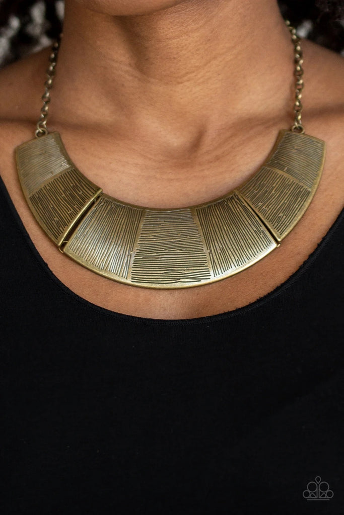 Etched in sections of vertical and horizontal linear textures, glistening antiqued brass plates link together, forming a bold half-moon pendant below the collar. Features an adjustable clasp closure.  Sold as one individual necklace. Includes one pair of matching earrings.