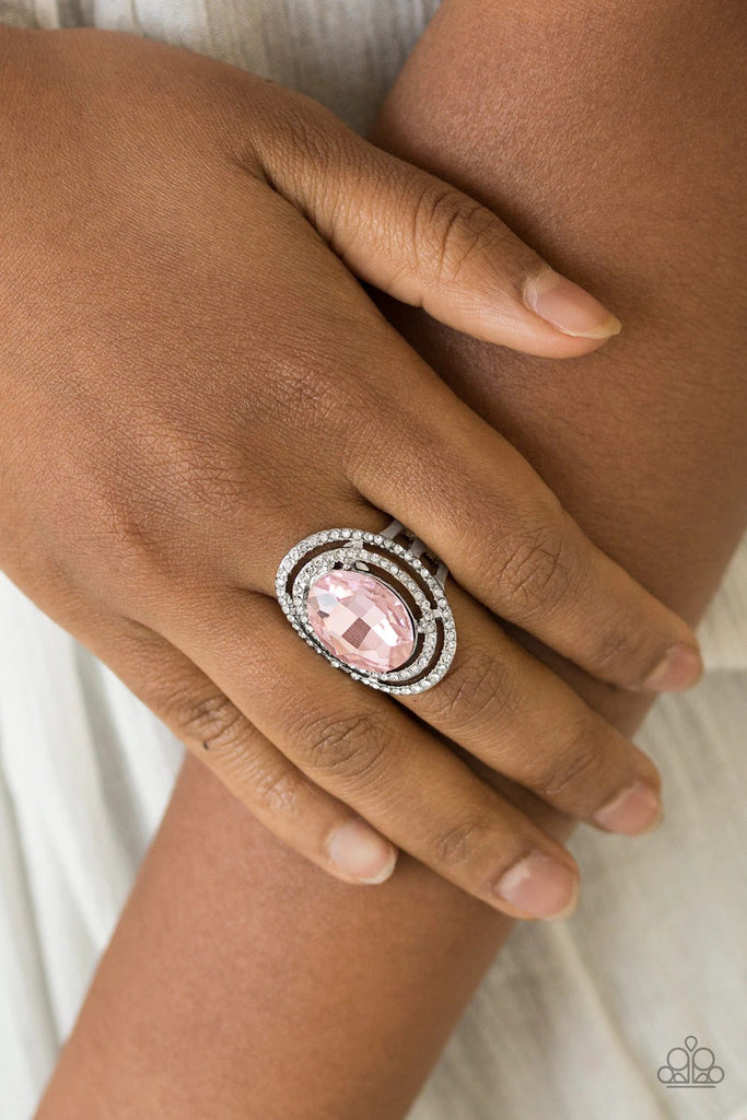 A glittery pink gem sits atop stacked silver frames radiating with glassy white rhinestones for a timeless look. Features a stretchy band for a flexible fit.  Sold as one individual ring.