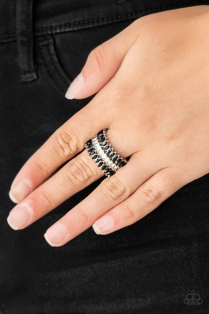 Featuring refined marquise cuts, glittery black rhinestones flare from a center of glassy white rhinestones, creating a regal band across the finger. Features a stretchy band for a flexible fit.  Sold as one individual ring.