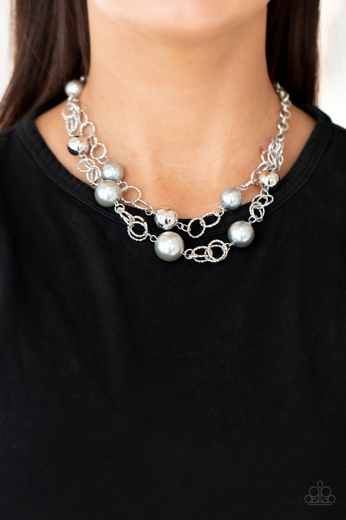 Sections of oversized textured silver links, silver pearls, and shiny silver beads haphazardly connect into two timeless layers below the collar, creating a dramatically refined display. Features an adjustable clasp closure.  Sold as one individual necklace. Includes one pair of matching earrings.  