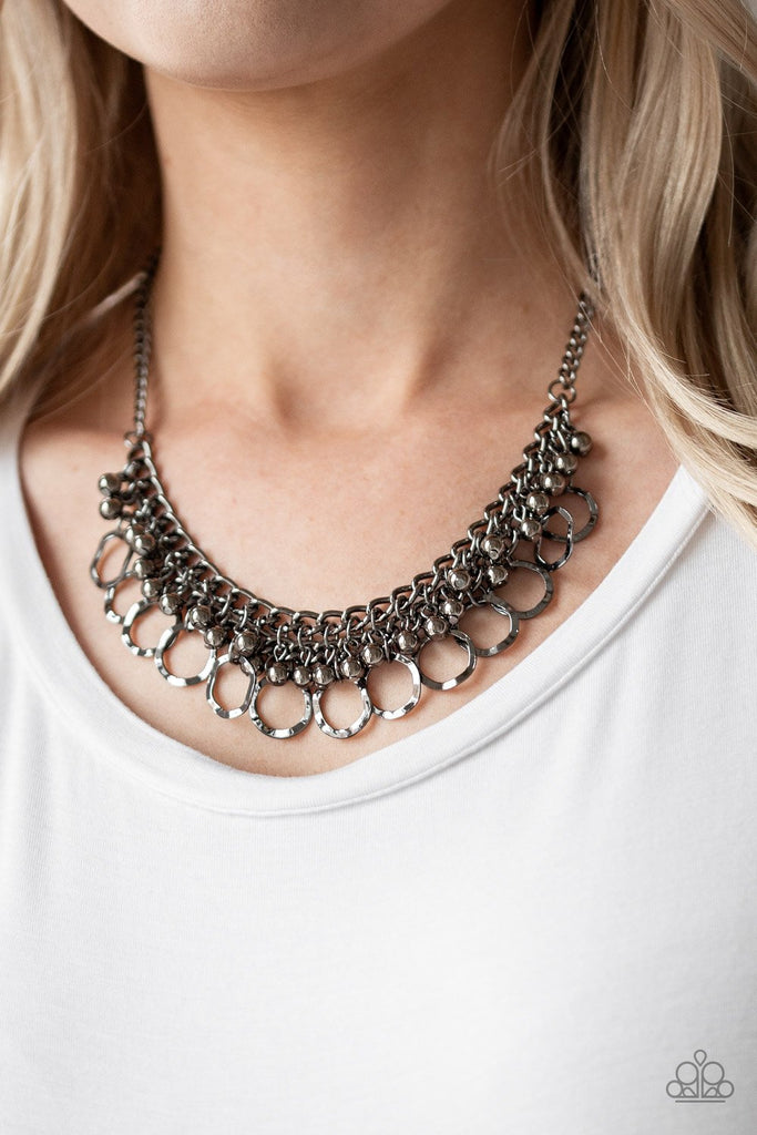 Rows of shiny gunmetal beads and hammered gunmetal rings swing from the bottom of interlocking gunmetal chains, creating a bold fringe below the collar. Features an adjustable clasp closure.  Sold as one individual necklace. Includes one pair of matching earrings.