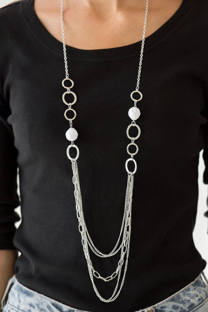 Faceted white beads and hammered silver hoops give way to layers of mismatched silver chains for a whimsical look. Features an adjustable clasp closure.  Sold as one individual necklace. Includes one pair of matching earrings.