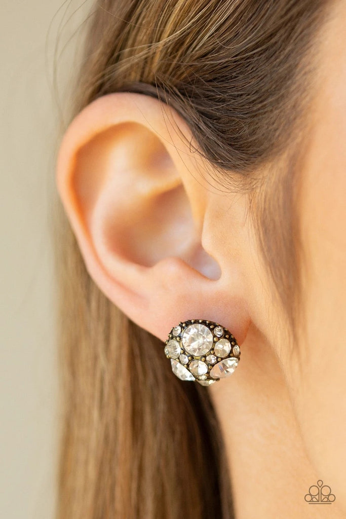 A collection of oversized and dainty white rhinestones is encrusted across the top of a round brass frame for a radiant look. Earring attaches to a standard post fitting.  Sold as one pair of post earrings.