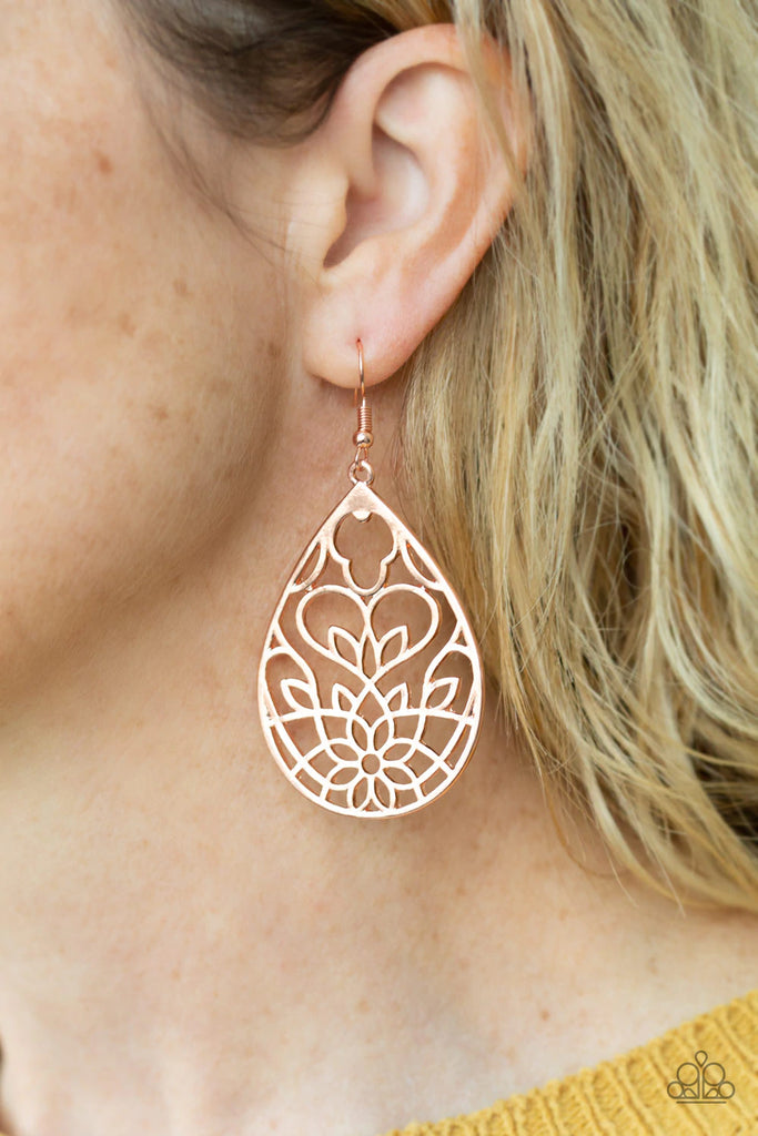 Shiny copper filigree swirls inside of an airy shiny copper teardrop frame, whirling into a whimsical lotus pattern for a seasonal look. Earring attaches to a standard fishhook fitting.  Sold as one pair of earrings.  