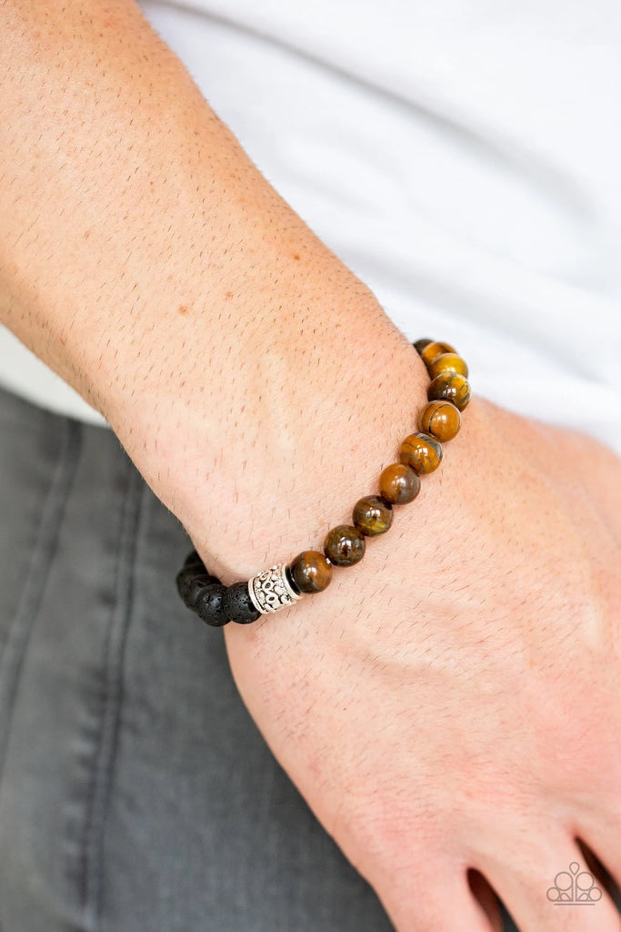 Infused with dainty silver accents, a collection of black lava rock beads and glassy tiger's eye stone beads are threaded along a stretchy band around the wrist for a seasonal style.  Sold as one individual bracelet.