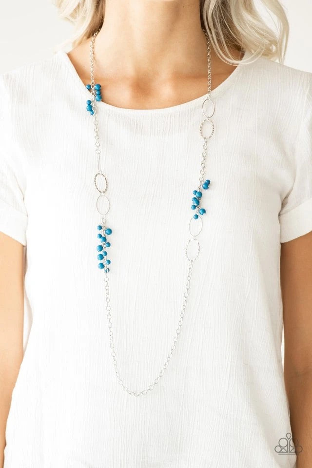 Smooth and hammered silver rings join clusters of refreshing blue beads along a shimmery silver chain for a colorful look. Features an adjustable clasp closure.  Sold as one individual necklace. Includes one pair of matching earrings.