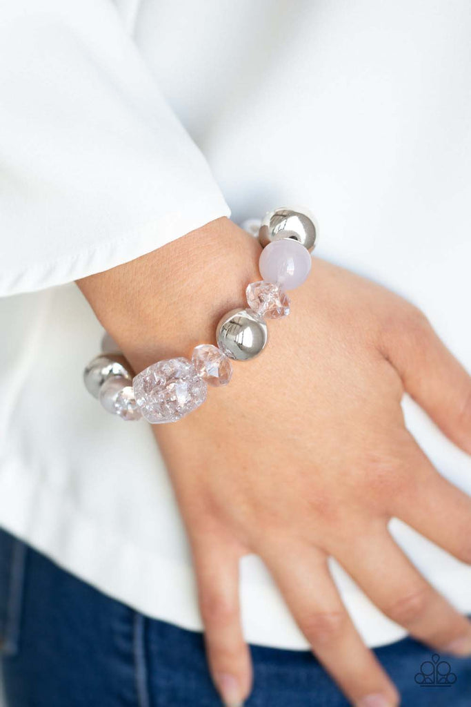 Infused with mismatched silver beads, a collection of opaque, polished, pearly, and crystal-like gray beads are threaded along a stretchy band around the wrist for a whimsical look.  Sold as one individual bracelet.
