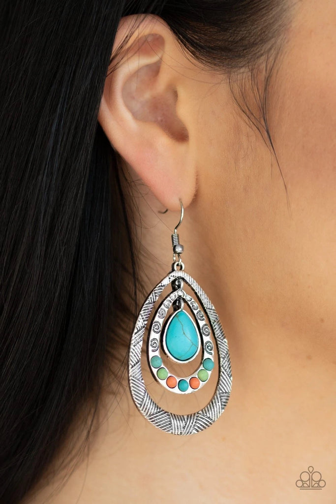 Stamped in swirls and crisscrossing linear textures, two shimmery silver frames ripple from a turquoise teardrop center. The bottom of the second frame is dotted in dainty turquoise, green, and orange stones for an earthy flair. Earring attaches to a standard fishhook fitting.  Sold as one pair of earrings.