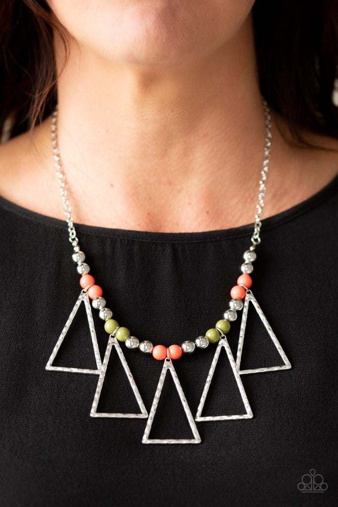 A collection of shiny silver, refreshing Living Coral, and zesty Pepper Stem beads are threaded along an invisible wire below the collar. Hammered triangular frames swing from the bottom of the colorful compilation, creating an artistic fringe. Features an adjustable clasp closure.  Sold as one individual necklace. Includes one pair of matching earrings.