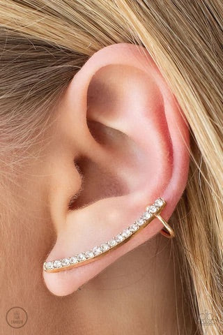 A dainty row of glassy white rhinestones are encrusted along a glistening gold bar that swoops up the ear for a sparkly style. Features a dainty cuff attached to the top for a secure fit.  Sold as one pair of ear crawlers.