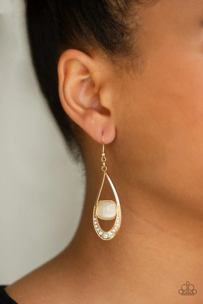 Dipped in white rhinestones, an abstract gold teardrop is nestled around a glowing cat's eye center for a refined look. Earring attaches to a standard fishhook fitting.  Sold as one pair of earrings.