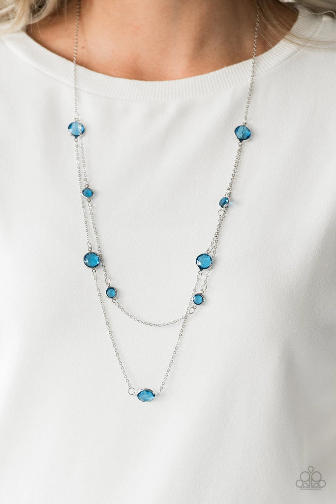 Varying in size, glassy blue gems trickle along dainty silver chains, creating sparkling layers across the chest. Features an adjustable clasp closure.  Sold as one individual necklace. Includes one pair of matching earrings.