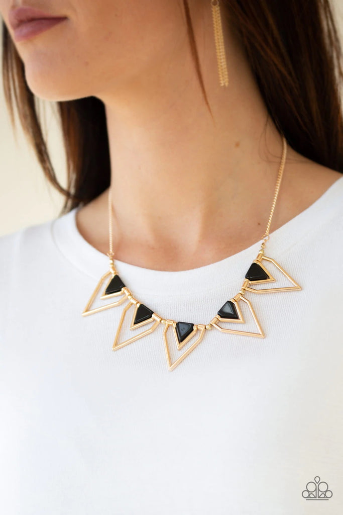 Infused with shiny black beading, glistening gold triangular frames join below the collar, creating a fierce geometric fringe. Features an adjustable clasp closure.  Sold as one individual necklace. Includes one pair of matching earrings.