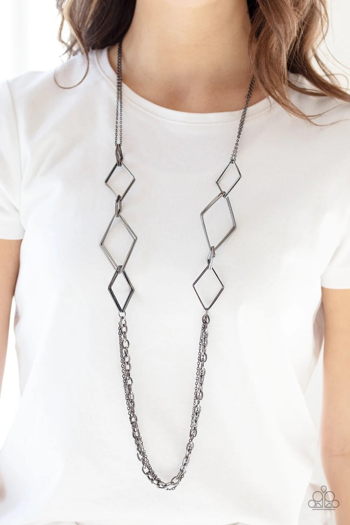 A collection of interlocking diamond-shaped frames give way to rows of mismatched gunmetal chains, creating edgy layers across the chest. Features an adjustable clasp closure.  Sold as one individual necklace. Includes one pair of matching earrings.
