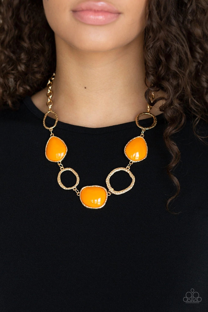 Delicately hammered in shimmery textures, asymmetrical gold rings and orange beaded frames link below the collar for a colorful look. Features an adjustable clasp closure.  Sold as one individual necklace. Includes one pair of matching earrings.