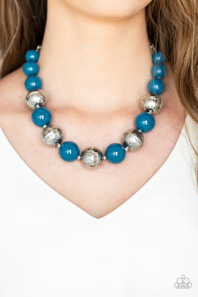 Infused with dainty silver accents, a bubbly collection of refreshing blue beads and floral embossed silver beads are threaded along an invisible wire below the collar for a seasonal look. Features an adjustable clasp closure.  Sold as one individual necklace. Includes one pair of matching earrings.  