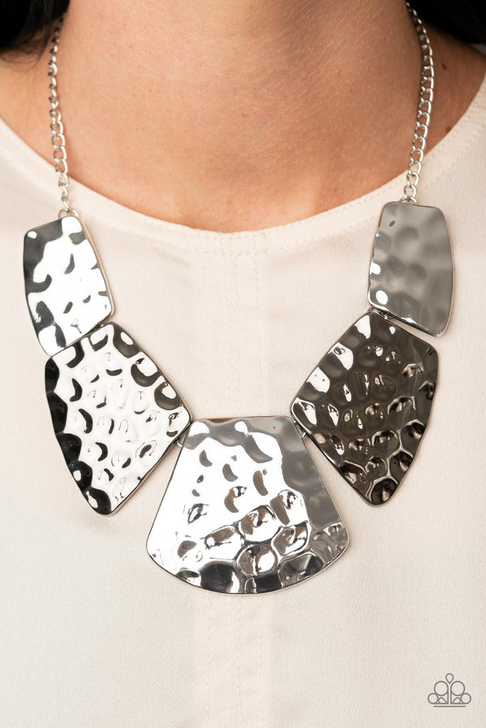 An oversized collection of hammered silver and gunmetal plates delicately link together below the collar, creating a boldly imperfect geometric fringe. Features an adjustable clasp closure.  Sold as one individual necklace. Includes one pair of matching earrings.