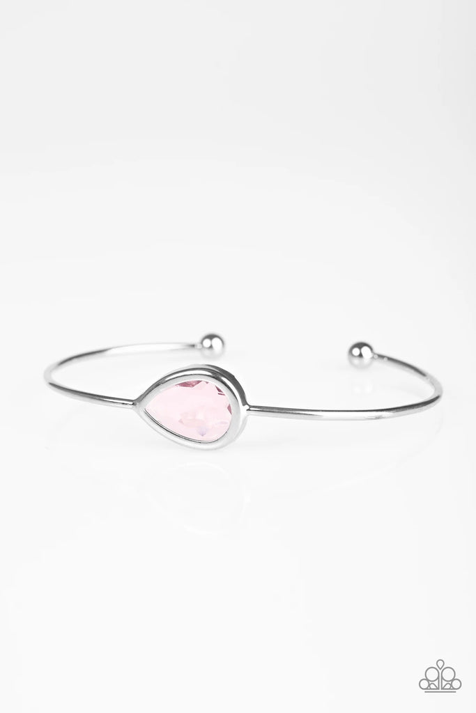 A glassy pink gem is pressed into a teardrop fitting in the center of a dainty silver cuff for a refined look.  Sold as one individual bracelet.