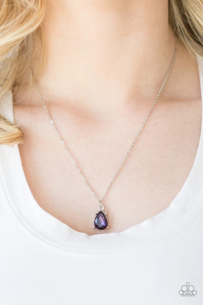 Featuring a regal teardrop cut, a glittery purple gem swings from the bottom of a dainty silver chain, creating a timeless pendant below the collar. Features an adjustable clasp closure.Sold as one individual necklace. Includes one pair of matching earrings.