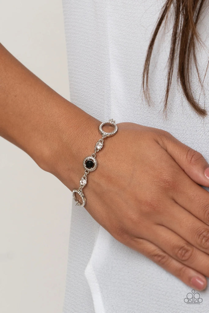 Infused with classic white rhinestones, a glittery collection of white rhinestone encrusted silver ovals and black rhinestone encrusted studded silver frames elegantly link around the wrist for a refined flair. Features an adjustable clasp closure.  Sold as one individual bracelet.