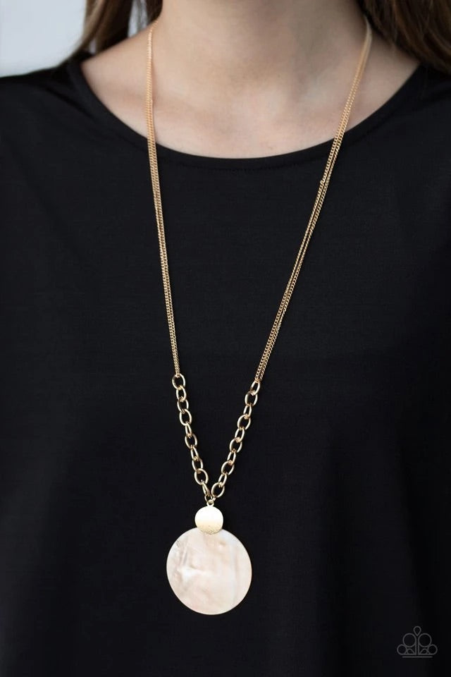 A textured gold disc links with a shell-like frame at the bottom of a section of thick gold chain, creating a summery pendant. Features an adjustable clasp closure.  Sold as one individual necklace. Includes one pair of matching earrings.