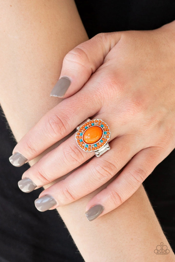 Dainty orange, blue, and brown beads encircle a larger orange bead, creating a colorful frame atop the finger. Features a stretchy band for a flexible fit.  Sold as one individual ring.  