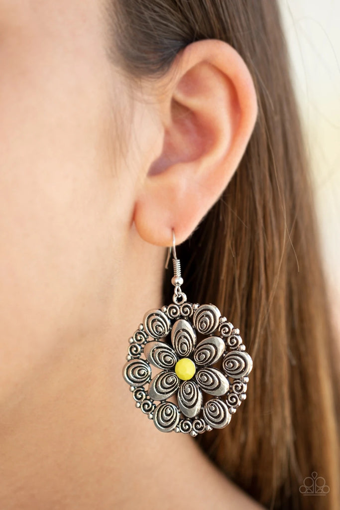 Dotted with a faceted yellow bead center, swirly silver petals bloom into a flowery frame for a whimsical look. Earring attaches to a standard fishhook fitting.  Sold as one pair of earrings.