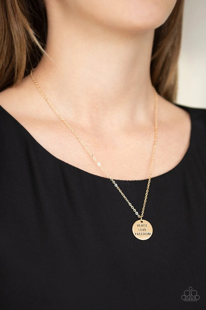 Stamped in the words, "Peace," "Love," and "Freedom," a shiny silver disc slides along a dainty silver chain below the collar for a patriotic inspired fashion. Features an adjustable clasp closure.  Sold as one individual necklace. Includes one pair of matching earrings.