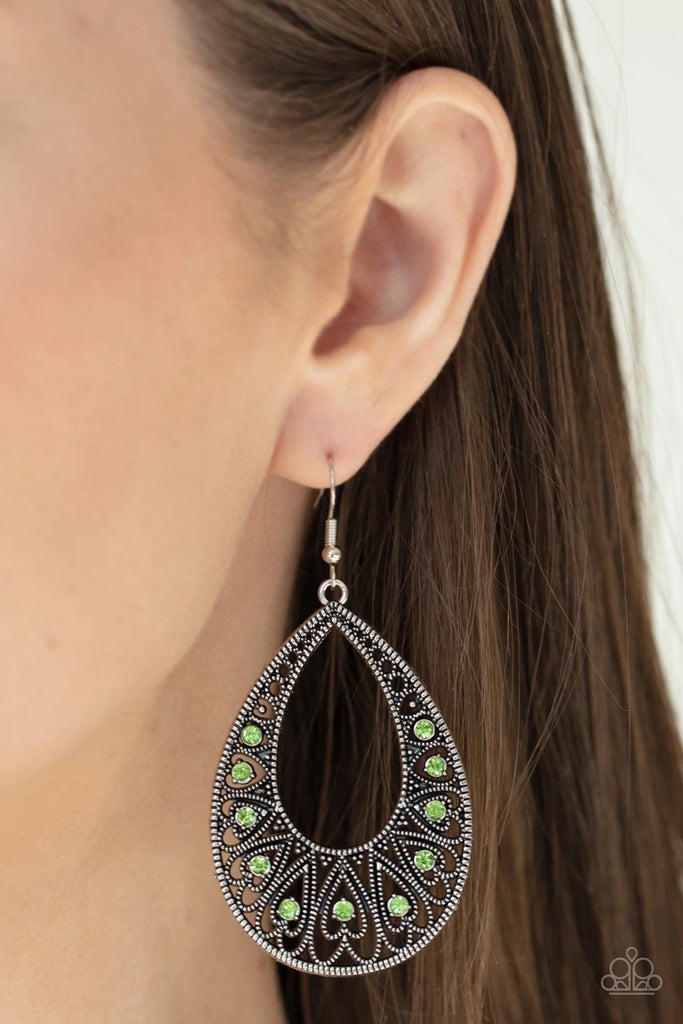 Dotted with dainty green rhinestone centers, studded silver heart frames fan out into a shiny silver teardrop frame for a lovable look. Earring attaches to a standard fishhook fitting.  Sold as one pair of earrings.