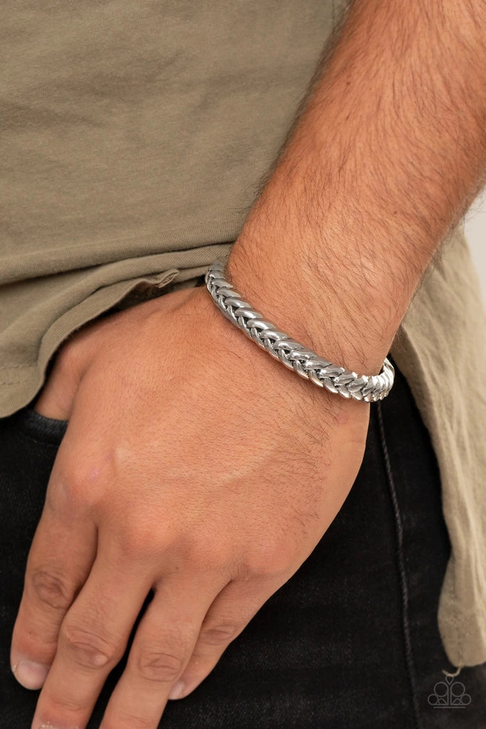 Infused with decorative silver fittings, antiqued silver bars thickly weave into a bold industrial cuff around the wrist.  Sold as one individual bracelet.