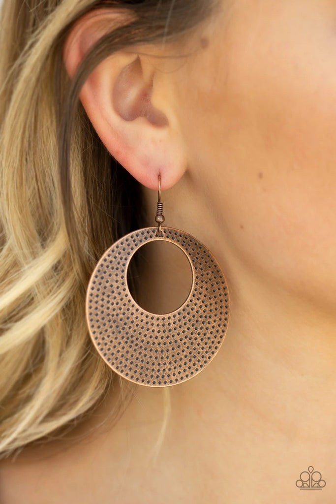 Dotted in a rippling pattern, a thick copper hoop swings from the ear for a casual shimmer. Earring attaches to a standard fishhook fitting.  Sold as one pair of earrings.