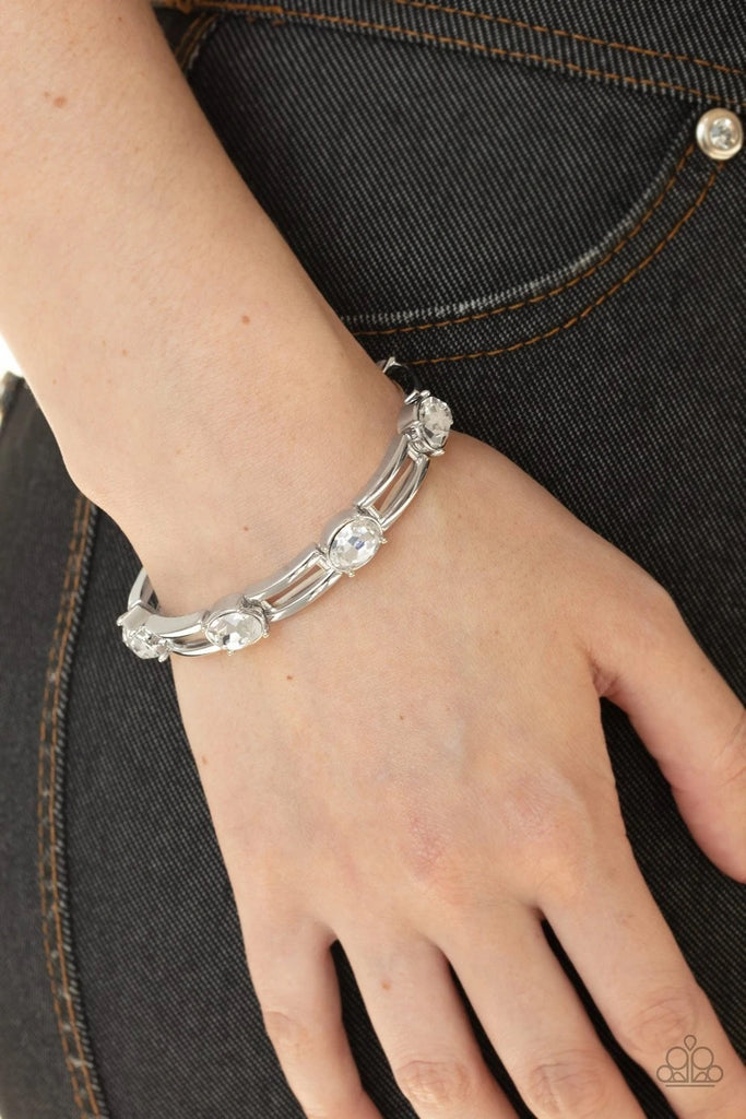 A glittery collection of white rhinestones and airy rectangular silver frames are threaded along stretchy bands around the wrist for a glitzy look.  Sold as one individual bracelet.