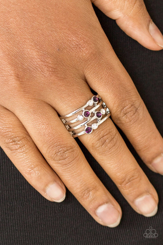 Glittery purple and white rhinestones are scattered along arcing silver bands, coalescing into a refined frame. Features a stretchy band for a flexible fit.  Sold as one individual ring.