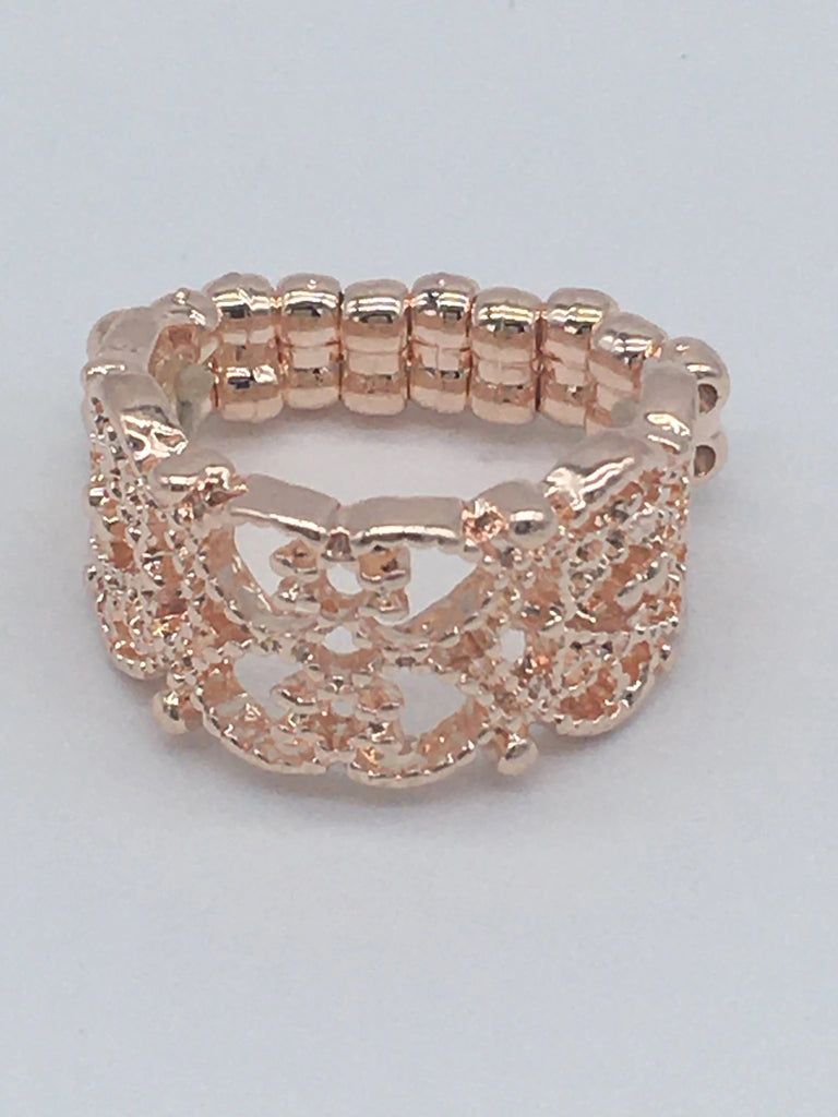 Dotted rose gold filigree whirls across the finger, creating a frilly band. Features a stretchy band for a flexible fit.  Sold as one individual ring.