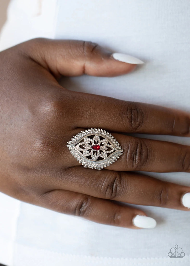 Encrusted in icy white rhinestones, glittery silver petals bloom from a fiery red teardrop rhinestone center, creating a glamorous centerpiece inside a frame of dramatically double-bordered rows of white rhinestones. Features a stretchy band for a flexible fit.  Sold as one individual ring.