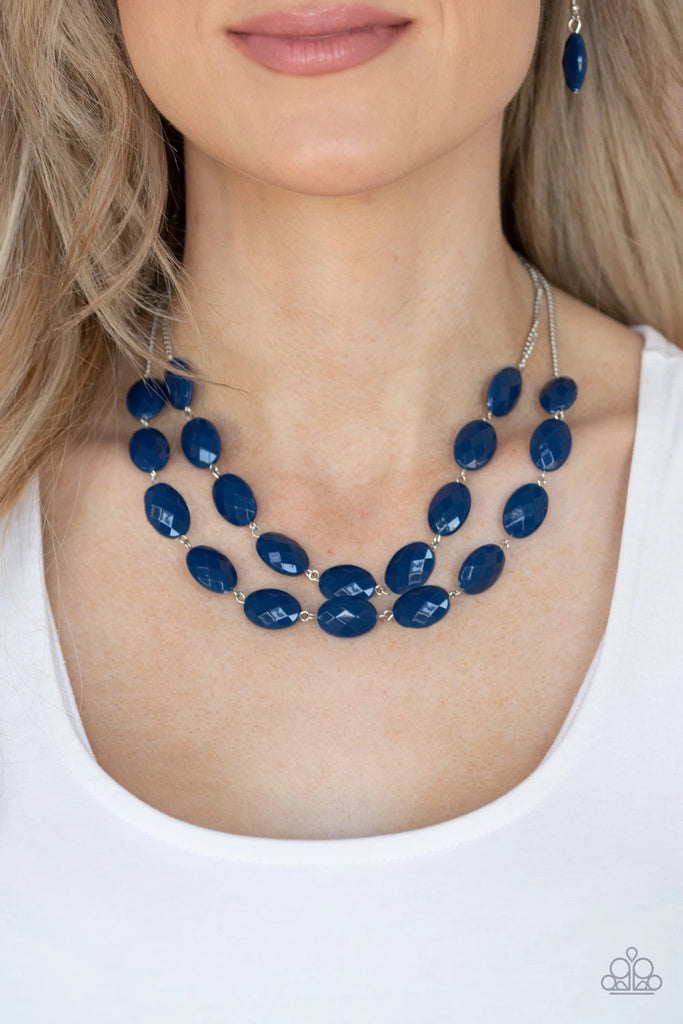 Attached to dainty silver chains, oval Classic Blue beads delicately link into colorful rows below the collar, adding a powerful splash of color to any outfit. Features an adjustable clasp closure.  Sold as one individual necklace. Includes one pair of matching earrings.