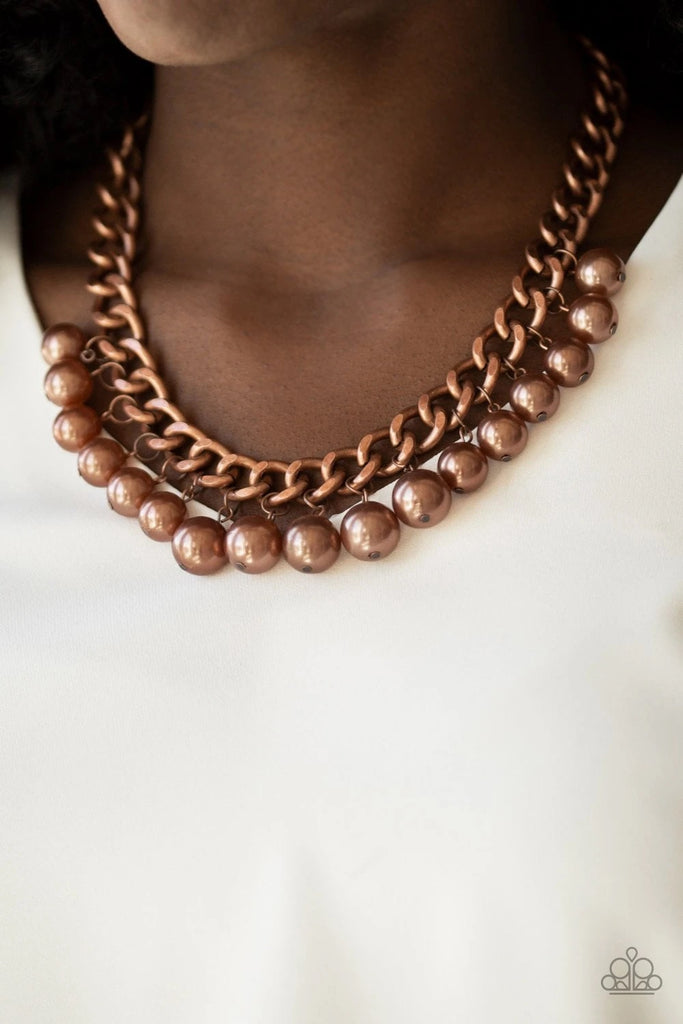 Bubbly copper pearls swing from the bottom of a hefty copper chain, creating a dramatic fringe below the collar. Features an adjustable clasp closure.  Sold as one individual necklace. Includes one pair of matching earrings.