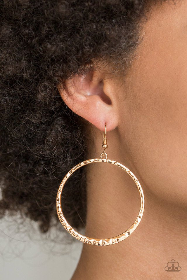 Delicately hammered in rippling shimmer, a glistening gold hoop swings from the ear for a classic look. Earring attaches to a standard fishhook fitting. Sold as one pair of earrings.
