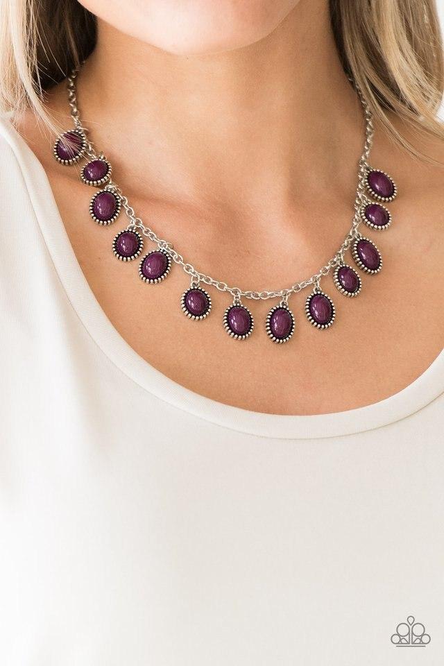 Infused with studded silver frames, round and oval purple beads swing from a shimmery silver chain, creating a vivacious fringe below the collar. Features an adjustable clasp closure.  Sold as one individual necklace. Includes one pair of matching earrings.