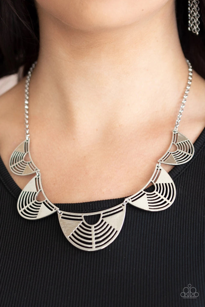 Featuring airy geometric cutouts, antiqued silver crescent shaped frames increase in size as they delicately link below the collar, creating an edgy fringe. Features an adjustable clasp closure.  Sold as one individual necklace. Includes one pair of matching earrings.